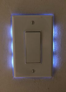 Wall paddle switch backlit with blue-white LED lights. It makes it glow from behind.