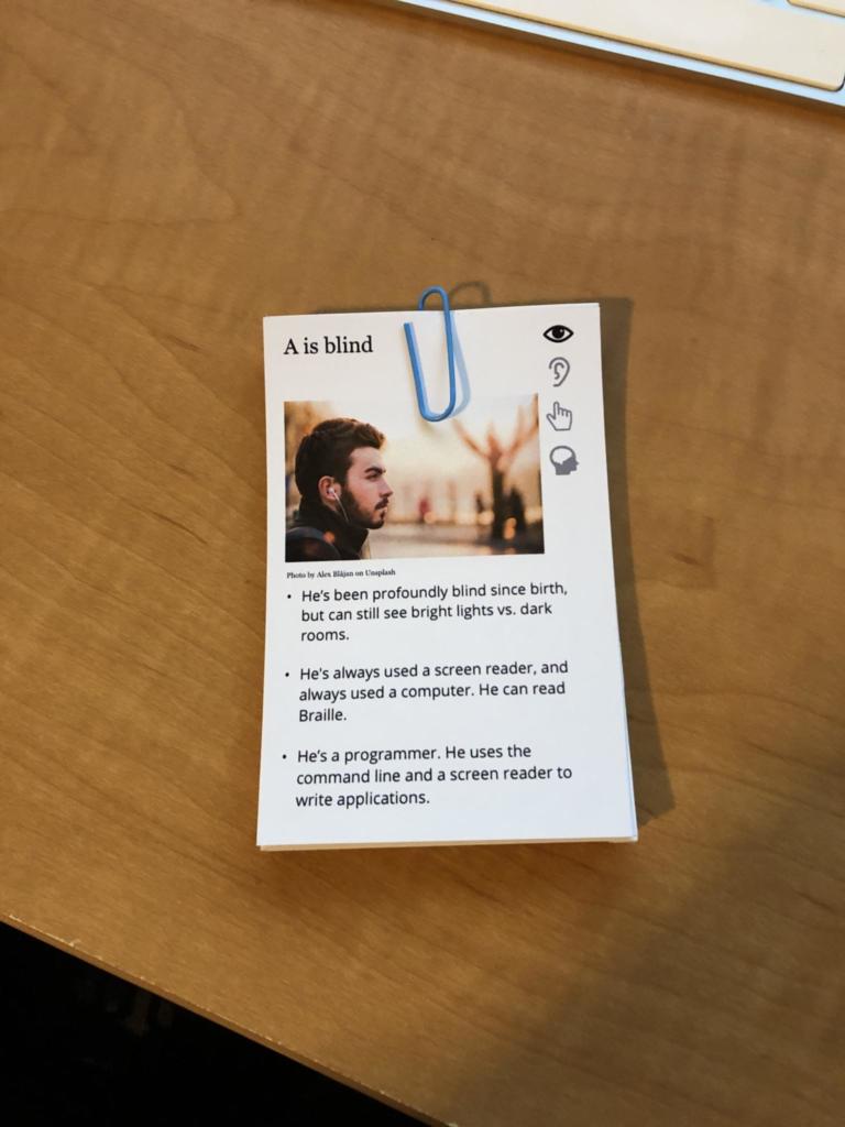 Prototype deck for An Alphabet of Accessibility. The letter A is the top card in the paper-clipped desk sitting on a desk.