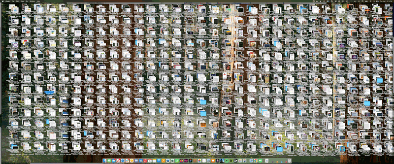 the desktop of a 38 inch monitor covered with so many icons they are stacked four deep